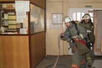 Пожарные тянут в здание корпуса рукав